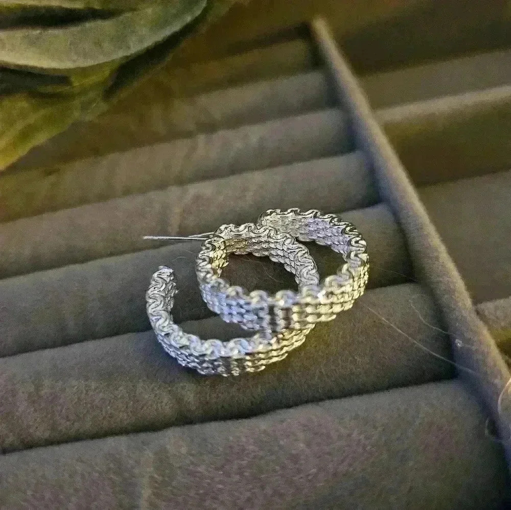 Sterling silver mesh pattern hooped earrings.